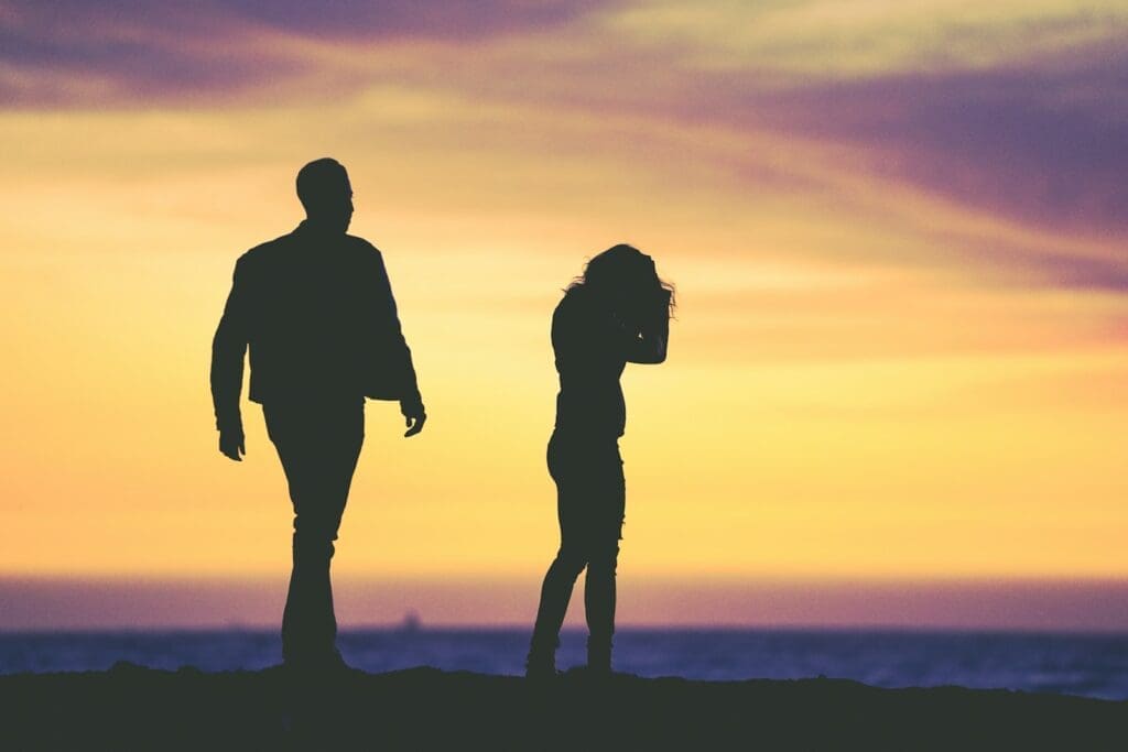 silhouette of man and woman under yellow sky Perimenopause and relationships can be difficult. 