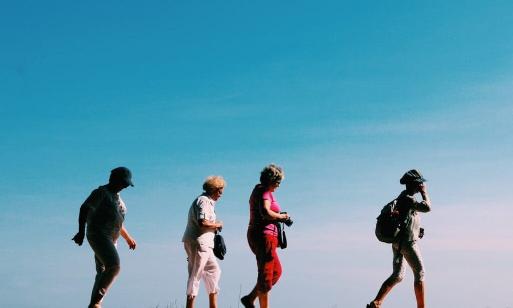 four older women walking against a blue sky in the sun. Prediabetes can be conquered at any age