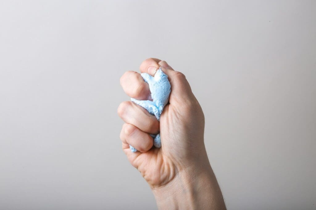 a person holding something in their left hand