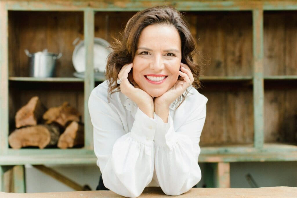 middle age woman with brown hair smiling. Perimenopause doesn't have to derail your happy life 