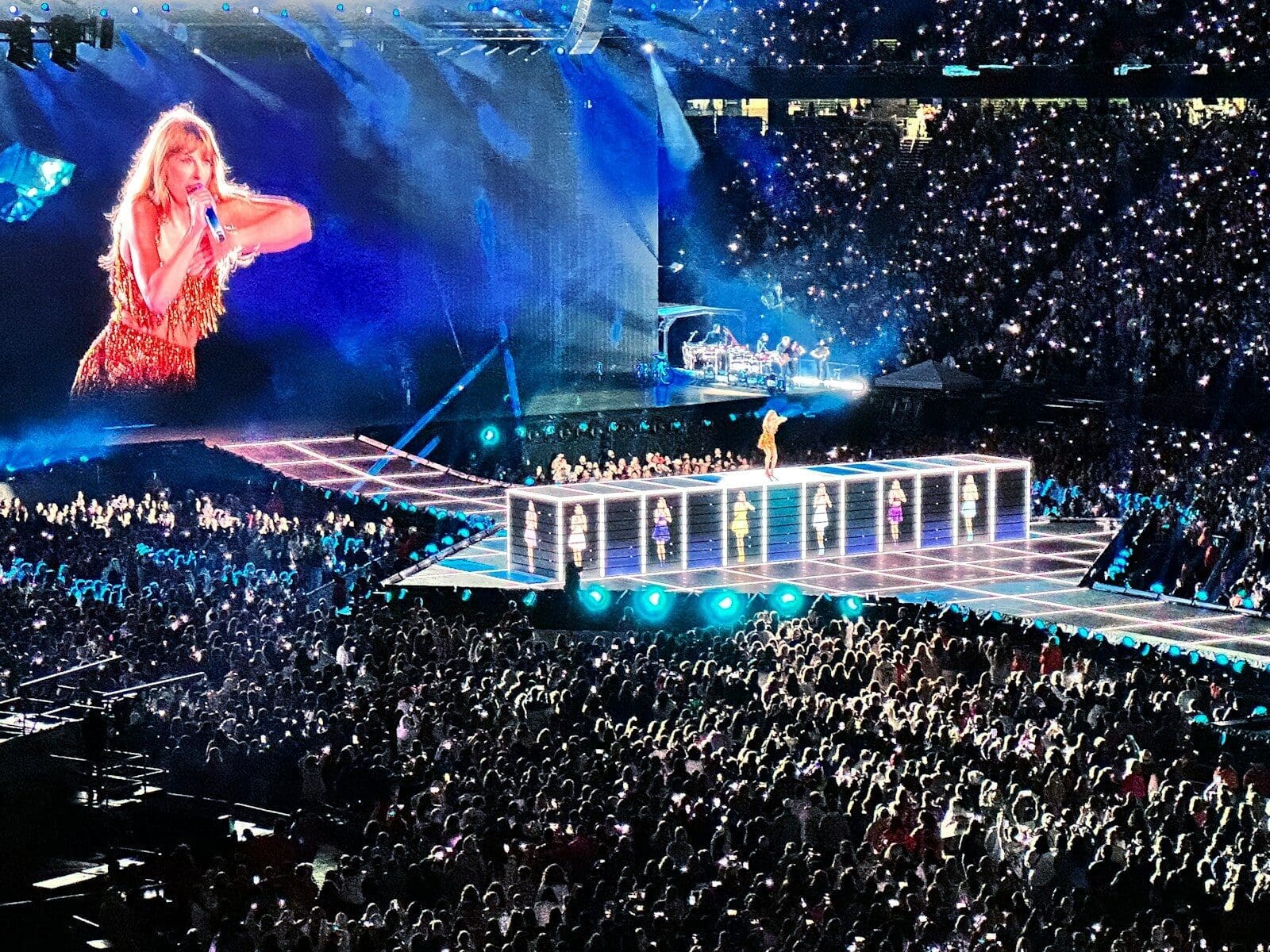 a crowd of people watching Taylor Swift on a stage. Perimenopause can strike in our 30's or any era